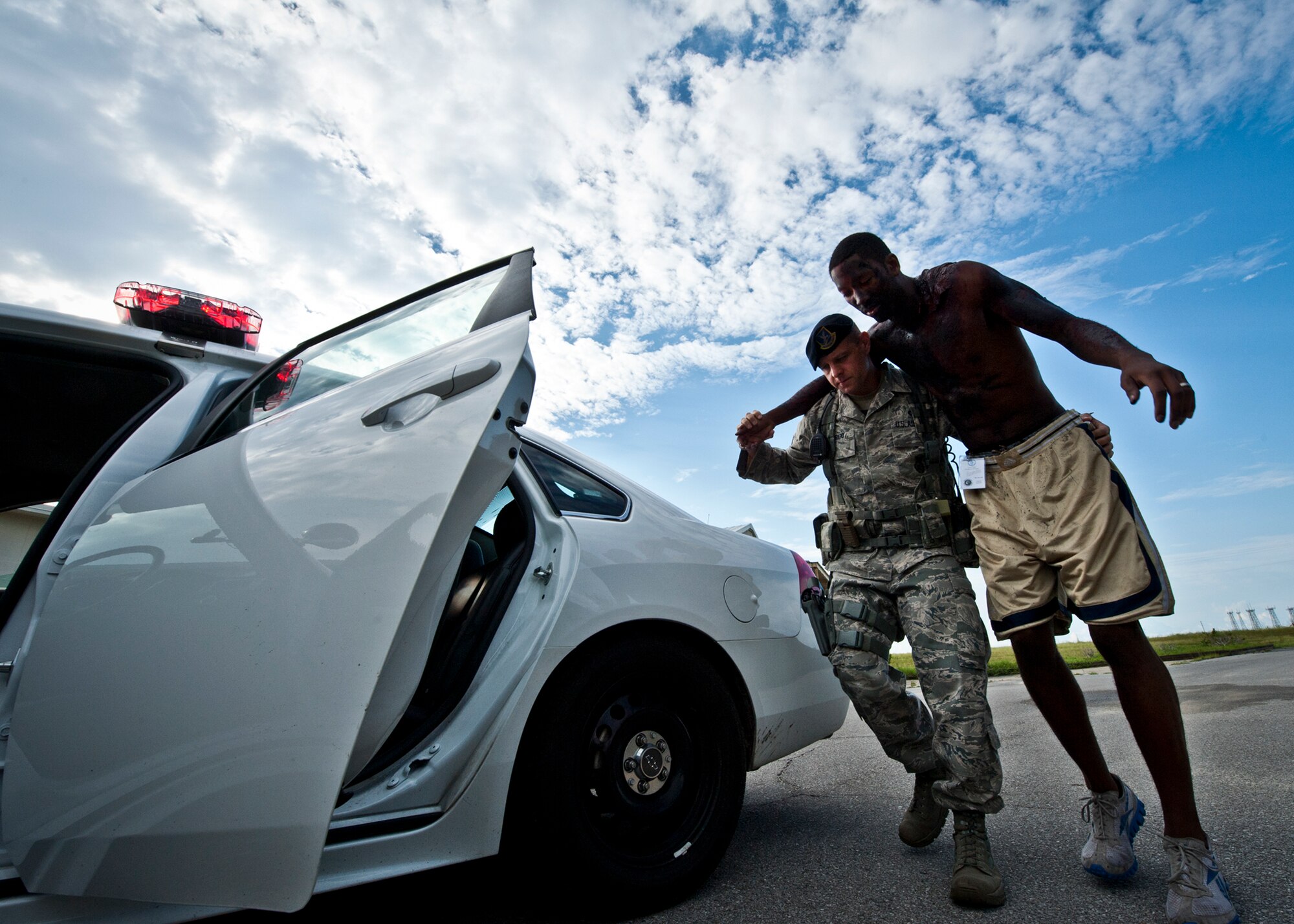 Tech. Sgt. Michael Marrero, a 96th Security Forces Squadron Airman, helps a victim of a simulated explosion during a Nuclear Accident Response Exercise at Eglin Air Force Base, Fla., Aug. 22.  Eglin agencies, including first responders, were evaluated on their reactions and responses to a vehicle explosion carrying nuclear material.  (U.S. Air Force photo/Samuel King Jr.)