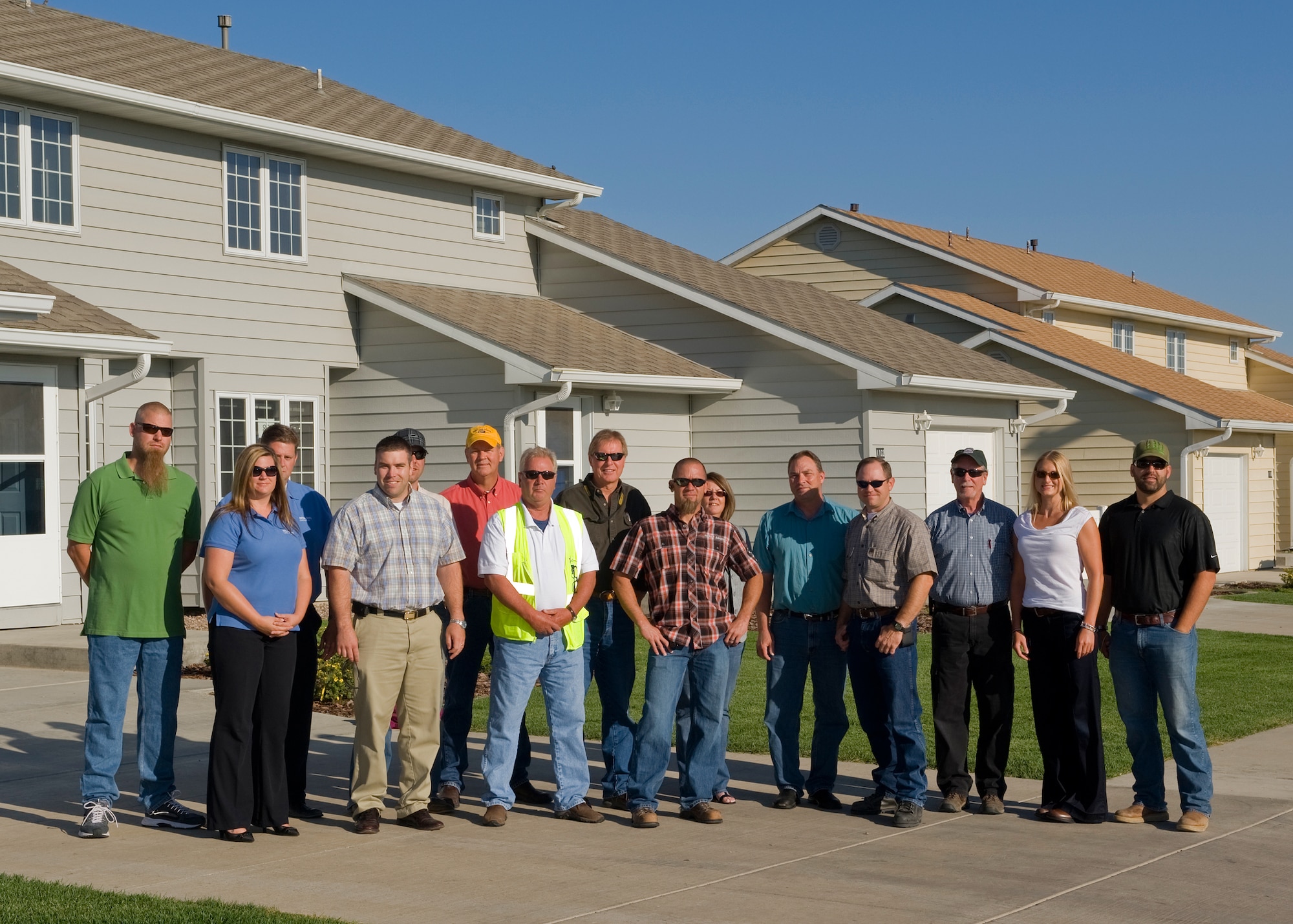 Following a ceremony recognizing the restoration of 171 housing units in Minuteman Village, representatives from Balfour Beatty Communities, Malmstrom’s housing management unit, SunStar LLC, project general contractor, U.S. Army Corps of Engineers Seattle District, project construction agent, and the 341st Civil Engineer Squadron, pose for a group photo on Aug. 17. (U.S. Air Force photo/Beau Wade)
