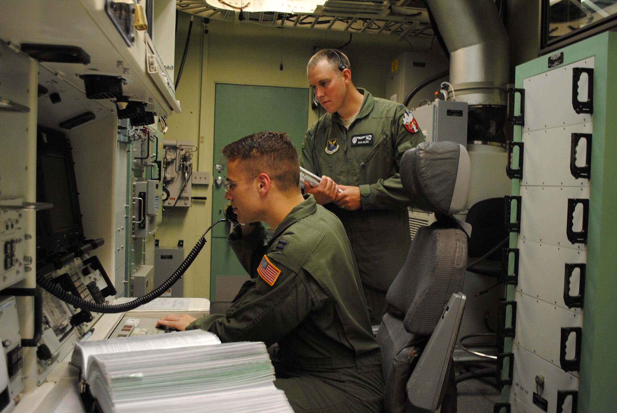 Hejde, right, watches Hepler practices a simulated procedure in the time allotted in the MPT on Aug. 17. Hejde is one of two trainers for the operations portion of the Global Strike Challenge. (U.S. Air Force photo/Airman 1st Class Katrina Heikkinen)