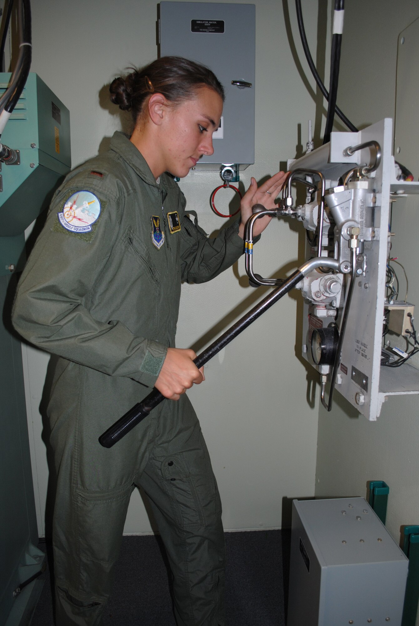 Guenther checks the settings on equipment in the missile procedures trainer on Aug. 17. Ten missileers, including two trainers and two alternate crew members, are training in the MPT six days a week in preparation for the competition. (U.S. Air Force photo/Airman 1st Class Katrina Heikkinen)