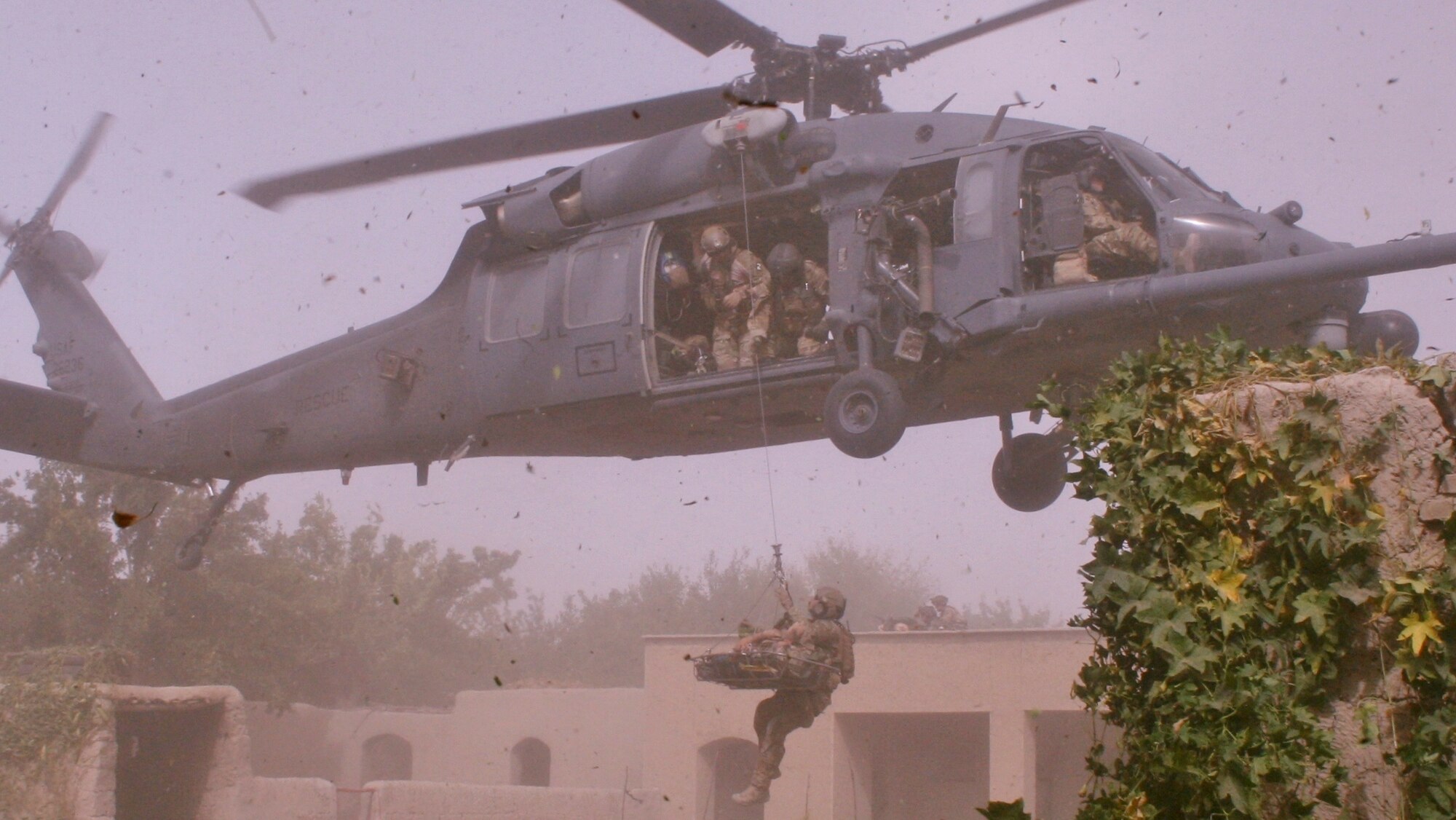 After responding to an improvised explovise device attack, Guardian Angels hoist a wounded Danish Army Solider into a HH-60G Pave Hawk. While deployed to Afghanistan, Guardian Angels from the 920th Rescue Wing, Patrick Air Force Base Fla., responded to a NATO foot patrol that ended due to life threatening injuries. (Courtesy photo)