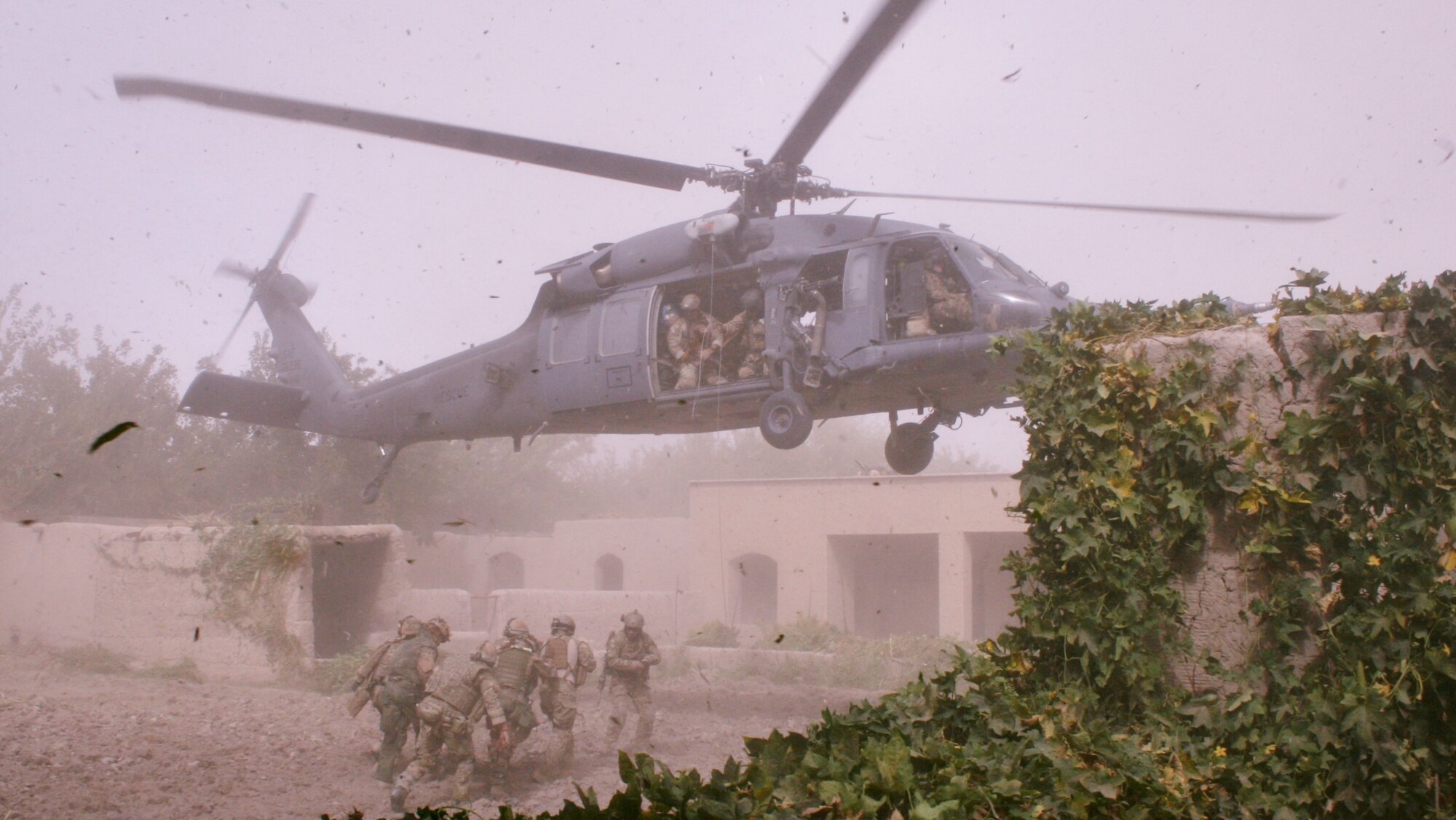 Guardian Angels carry a liter with a wounded Danish Army Solider to a hoist line from a hovering HH-60G Pave Hawk. While deployed Guardian Angels from the 920th Rescue Wing, Patrick Air Force Base Fla., responded to a NATO foot patrol in Afghanistan that ended with life threatening injuries. (Courtesy photo)