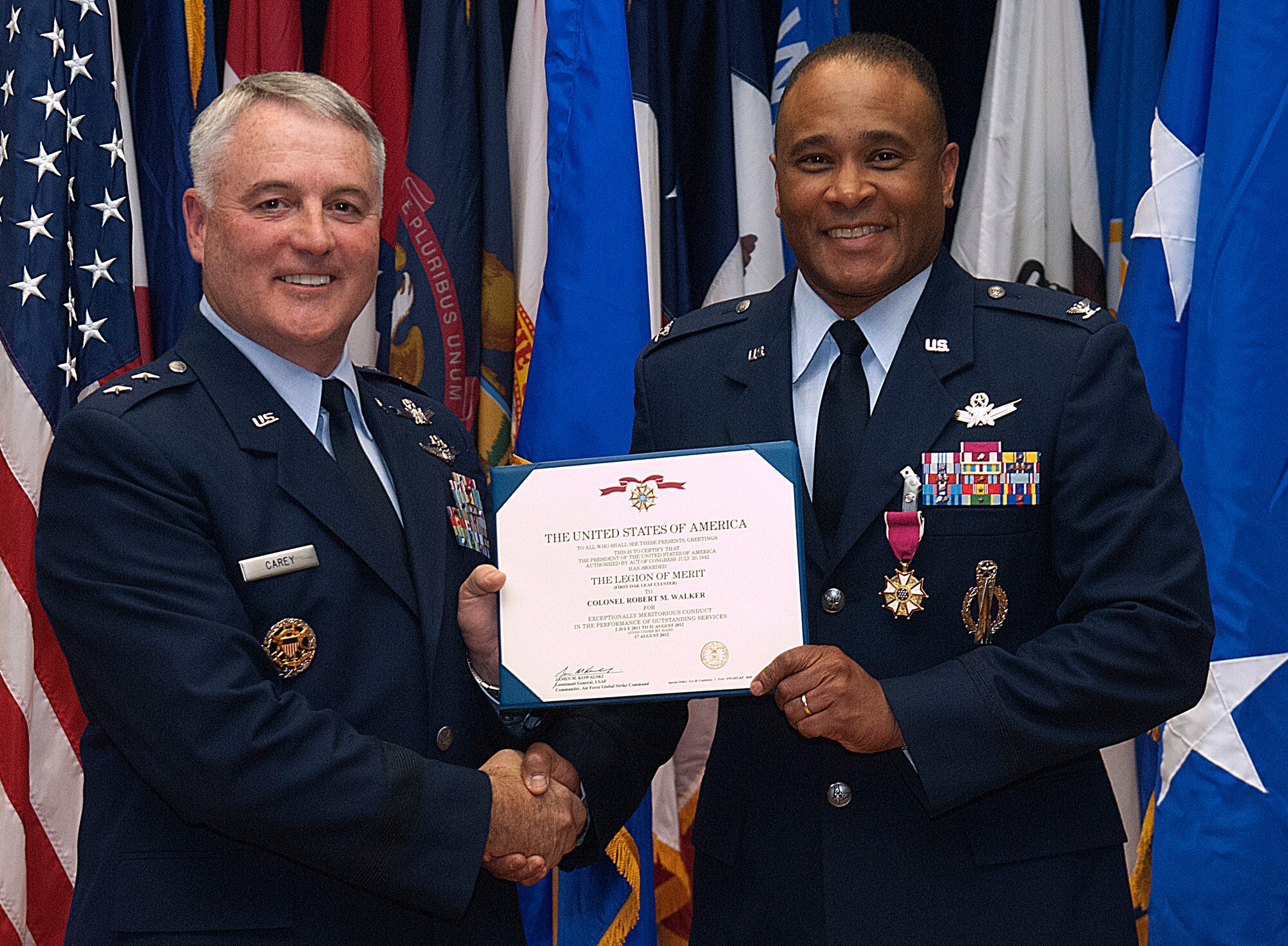 Maj. Gen. Michael J. Carey, 20th Air Force commander, and Col. Robert Walker hold Walker’s Legion of Merit citation during his retirement ceremony at the Base Museum Aug. 17. Walker retired from the United States Air Force after more than 31 years of military service. (U.S. Air Force photo by R.J. Oriez)