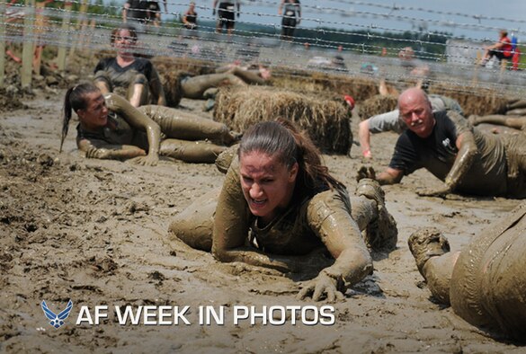 Staff Sgt. Ashley Davin low crawls through the mud in Amesbury, Mass., Aug. 11, 2012. Davin  is with the 102nd Security Forces Squadron and was participating in the Spartan Race, testing her strength, endurance, and resilience against a course of challenging obstacles. (Air National Guard photo/Senior Airman Jeremy Bowcock)

