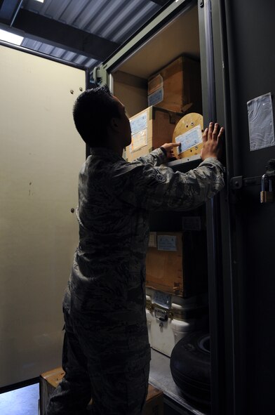 U.S. Air Force Airman 1st Class Rey Jee Quilla, 23d Logistics Readiness Squadron mobility spare readiness package apprentice, rearranges packaged aircraft parts at Moody Air Force Base, Ga., Aug. 22, 2012. Aircraft parts are stored for future deployments and to create space for incoming shipments. (U.S. Air Force photo by Airman 1st Class Olivia Dominique/Released)