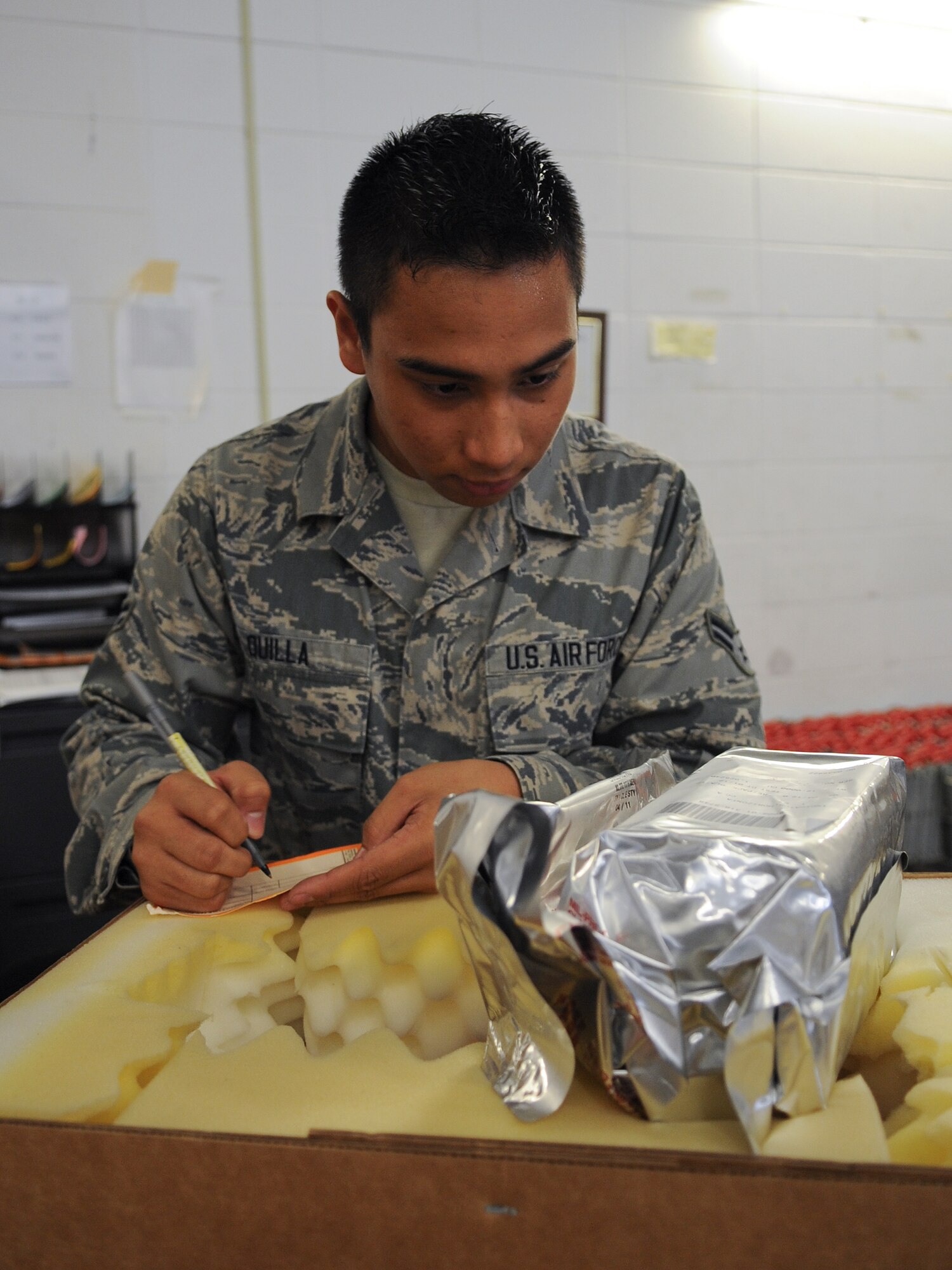 U.S. Air Force Airman 1st Class Rey Jee Quilla, 23d Logistics Readiness Squadron mobility spare readiness package apprentice, creates a label for an aircraft part at Moody Air Force Base, Ga., Aug. 22, 2012. All parts that arrive at the store are checked to ensure serviceability before being added to the inventory. (U.S. Air Force photo by Airman 1st Class Olivia Dominique/Released)