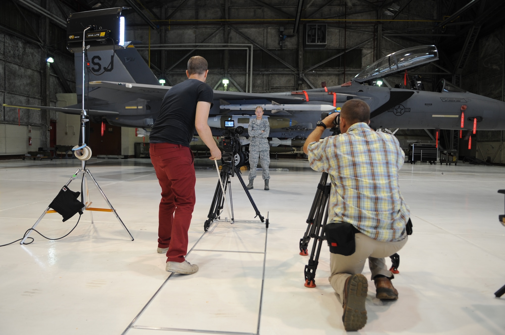 Members of film crew record U.S. Air Force Airman 1st Class Jenna Bishop, 757th Aircraft Maintenance Squadron aircraft armament systems journeyman, Nellis Air Force Base, Nev., for an Air Force Recruiting Service commercial on Seymour Johnson Air Force Base, N.C., Aug. 7, 2012. A more than 20-person team was tasked with the commercial in order to highlight several career fields the Air Force has to offer. (U.S. Air Force photo/Airman 1st Class Aubrey Robinson/Released)