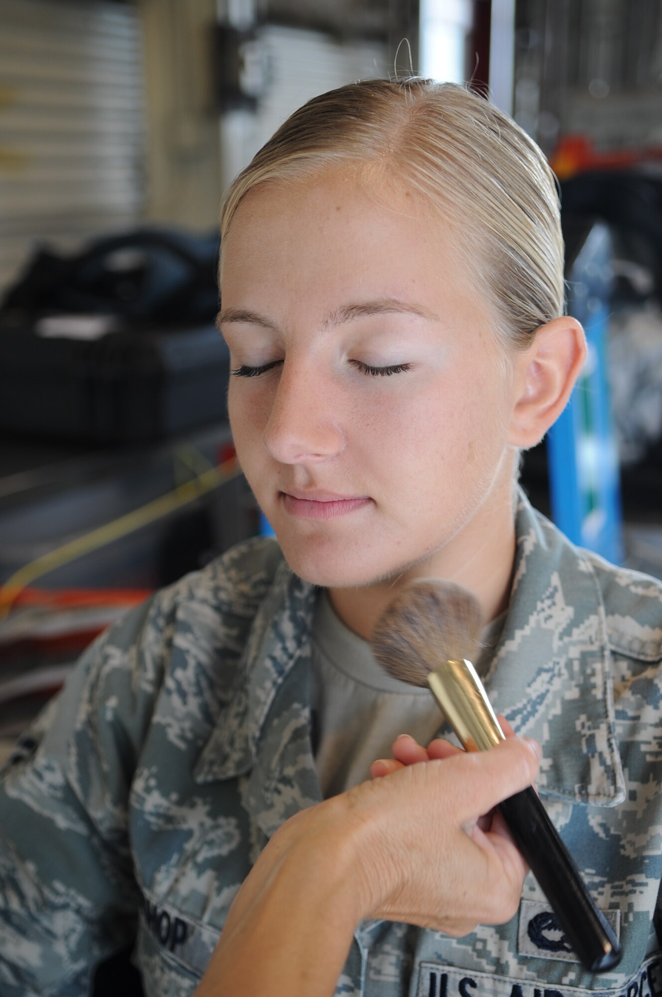 U.S. Air Force Airman 1st Class Jenna Bishop, 757th Aircraft Maintenance Squadron aircraft armament systems journeyman, Nellis Air Force Base, Nev., has her face powdered by a make-up artist prior to filming an Air Force Recruiting Service commercial on Seymour Johnson Air Force Base, N.C., Aug. 7, 2012. The commercial was filmed with the intent to inspire people to become anything they want through a career in Air Force. (U.S. Air Force photo/Airman 1st Class Aubrey Robinson/Released)
