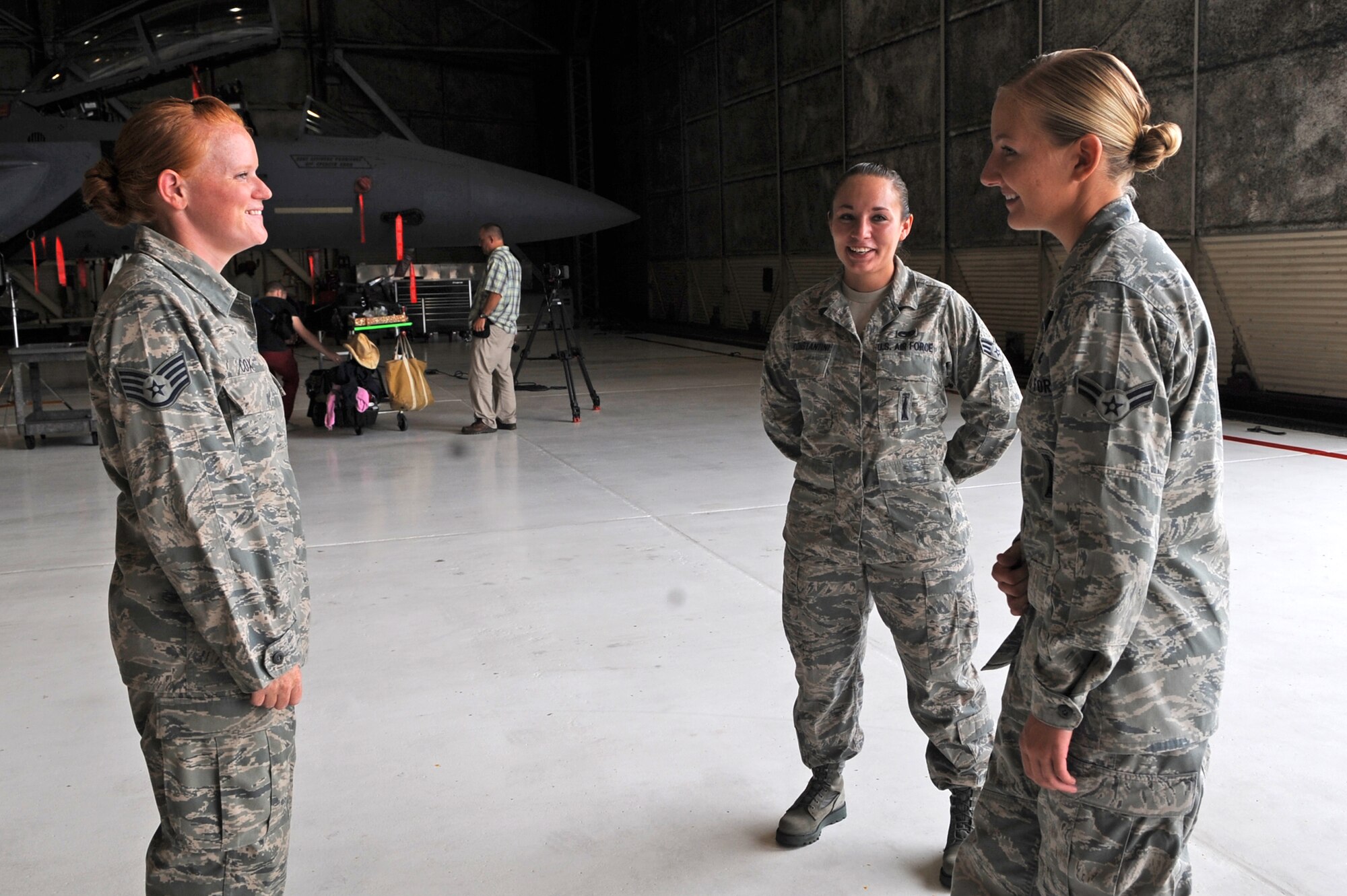 U.S. Air Force Airmen assigned to the 4th Fighter and 57th Wings laugh between scenes while filming an Air Force Recruiting Service commercial on Seymour Johnson Air Force Base, N.C., Aug. 7, 2012. While on set, the Airmen quickly bonded over their experiences with working on aircraft at their respective bases. (U.S. Air Force photo/Airman 1st Class Aubrey Robinson/Released)
