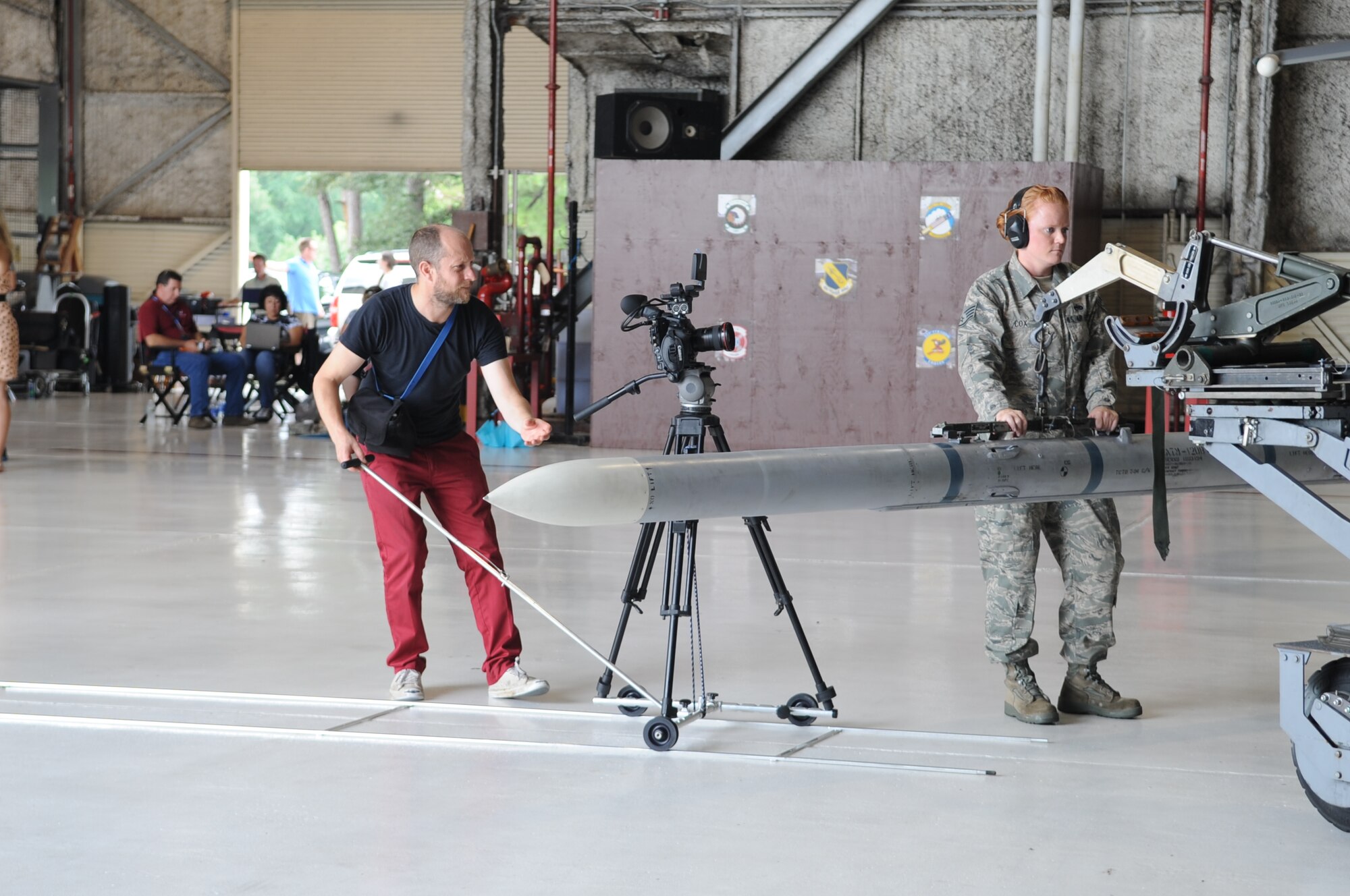 Trevor Fife, commercial director, films U.S. Air Force Staff Sgt. Dawn Cox, 4th Maintenance Operations Squadron weapons standardization load crew member, during the production of an Air Force Recruiting Service commercial on Seymour Johnson Air Force Base, N.C., Aug 7, 2012. Several members of Team Seymour from various career fields were highlighted in order to show the diversity of jobs the Air Force has to offer. (U.S. Air Force photo/Airman 1st Class Aubrey Robinson/Released)