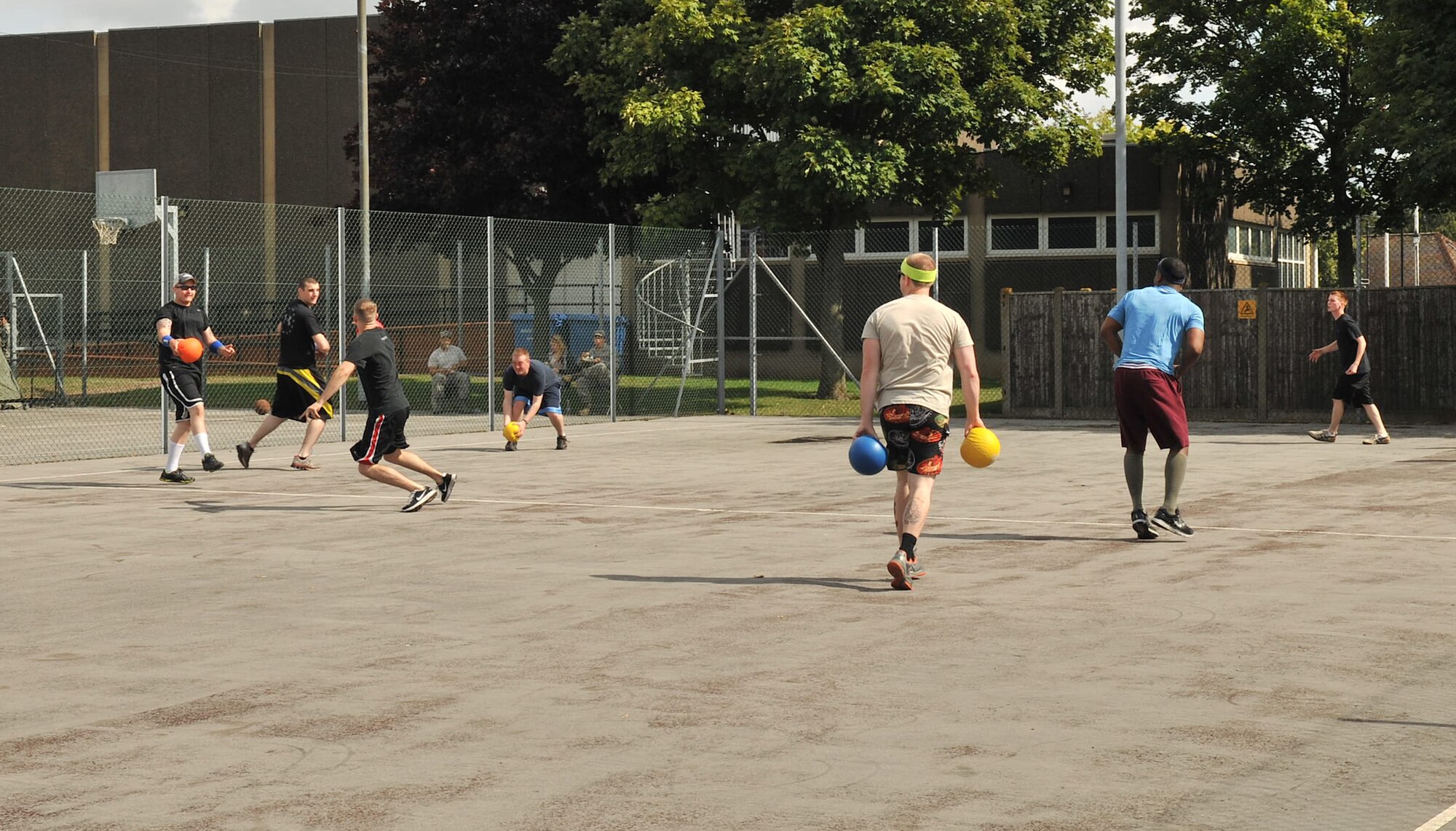 RAF MILDENHALL, England – Airmen assigned to Team Mildenhall participate in a dodge ball tournament Aug. 23, 2012, at the outdoor basketball court. The tournament was part of the Unaccompanied Airmen Appreciation Day event and just one of several free games and activities held during the day. (U.S. Air Force photo/Senior Airman Jerilyn Quintanilla)