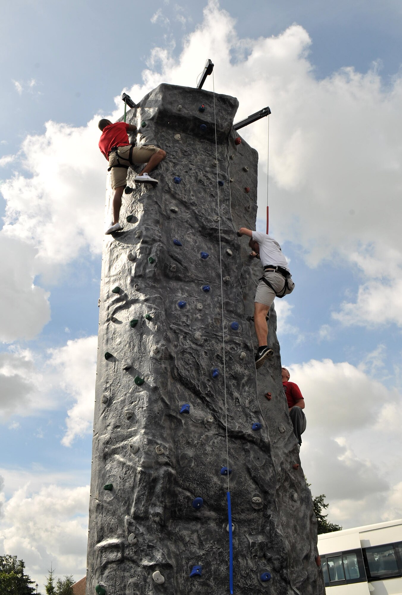 RAF MILDENHALL, England – From left, Airmen 1st Class Jerry Jackson III, 100th Air Refueling Wing command post, Adam McJunkin and Derek Armstrong, both from the 352nd Special Operations Support Squadron, make their way to the top of the rock climbing wall during the Unaccompanied Airmen Appreciation Day Aug. 23, 2012, in the Bob Hope Community Center parking lot. The UAAD events were open to all unaccompanied Airmen assigned to Team Mildenhall. (U.S. Air Force photo/Senior Airman Jerilyn Quintanilla) 