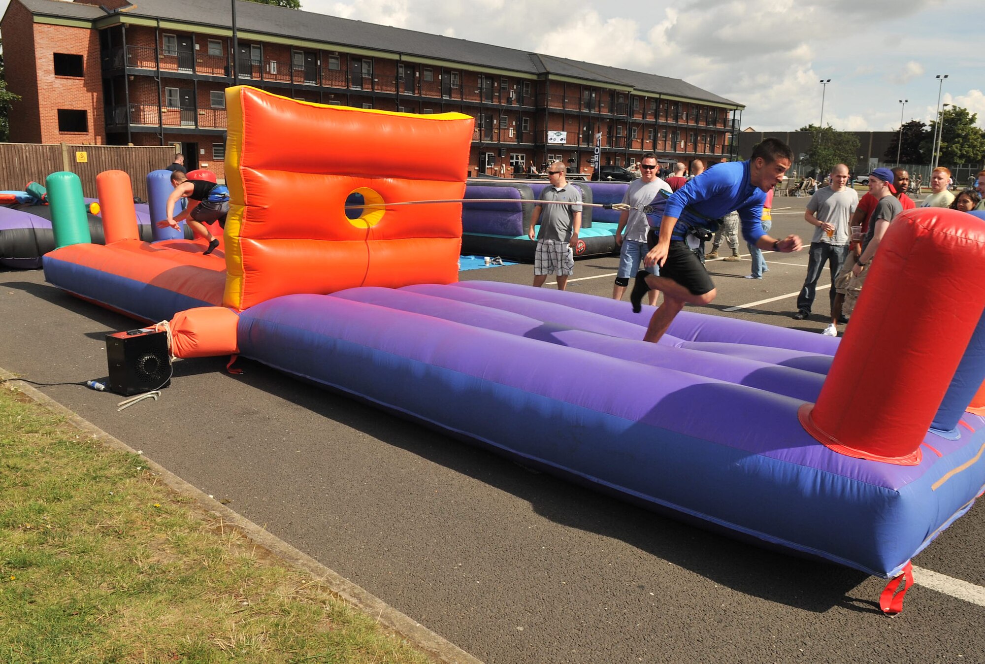 RAF MILDENHALL, England – Airman 1st Class Jeremy Lovell, 100th Communications Squadron, and Airman Brian Adamson, 100th Civil Engineer Squadron, challenge each other on the bungee run during the Unaccompanied Airmen Appreciation Day Aug. 23, 2012, in the Bob Hope Community Center parking lot. At the event, free activities, games and food were available to all unaccompanied Airmen assigned to Team Mildenhall. (U.S. Air Force photo/Senior Airman Jerilyn Quintanilla)