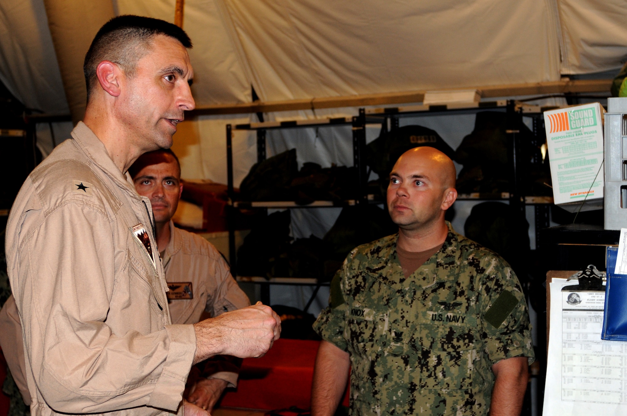 U.S. Navy Rear Admiral Matthew Carter, Patrol and Reconnaissance Force Fifth/Seventh Fleet commander, talks as Executive Officer James Kennedy and Aviation Structural Mechanic (Safety Equipment) Petty Officer 2nd Class Thomas Knox listen during his visit to the CTG 57 in Southwest Asia, August 15, 2012. The primary mission of CTG 57 is to conduct reconnaissance and maritime patrol operations throughout the 5th Fleet Area of Responsibility in support of the global war on terrorism. (U.S. Air Force photo/Captain Craig Carper)