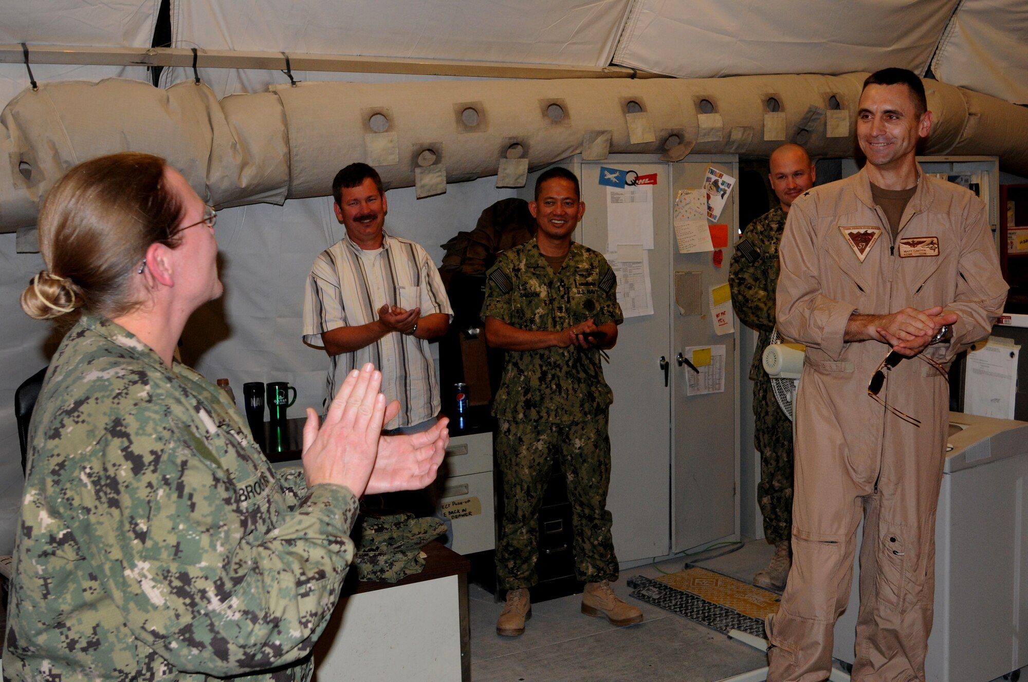U.S. Navy Rear Admiral Matthew Carter, Patrol and Reconnaissance Force Fifth/Seventh Fleet commander wishes Aviation Maintenance Administration Petty Officer 2nd Class Amy Brookins a ?Happy Birthday? as he leads shipmates in singing to honor her birthday during his visit to the CTG 57.1 in Southwest Asia, August 15, 2012. The primary mission of CTG 57.1 is to conduct reconnaissance and maritime patrol operations throughout the 5th Fleet Area of Responsibility in support of the global war on terrorism. (U.S. Air Force photo/Captain Craig Carper)