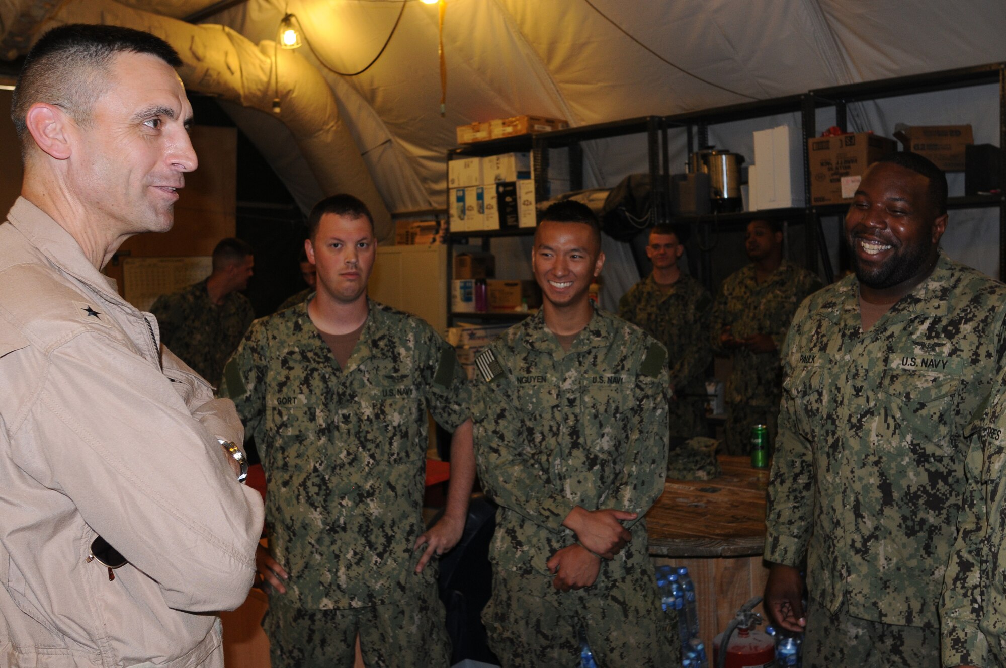 U.S. Navy Rear Admiral Matthew Carter, Patrol and Reconnaissance Force Fifth/Seventh Fleet commander, meets with Aviation Technician Nicholas Gort, Aviation Technician Dison Nguyen, Aviation Machinist Mate Marlon Paulk and Aviation Machinist Mate Jose Florres prior to coining them for their extraordinary team work and efforts in returning three engine assets to full mission capability. The sailors are assigned to CTG 57.1 as part of VQ-1. They are based at the 379th Air Expeditionary Wing in Southwest Asia, August 15, 2012. (U.S. Air Force photo/Captain Craig Carper)