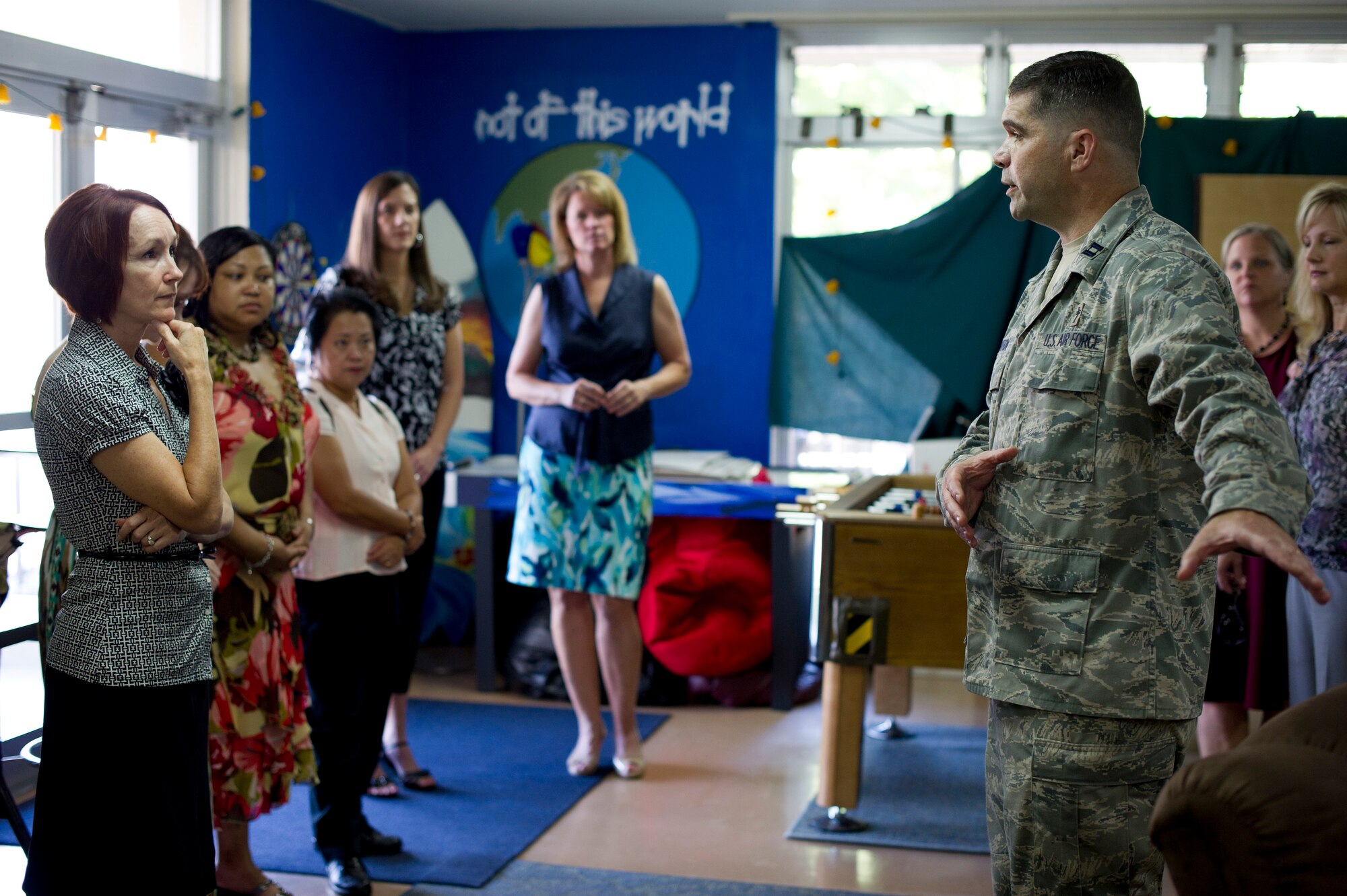 YOKOTA AIR BASE, Japan -- Chaplain (Capt.) David Horton, 374th Airlift Wing, gives a tour of the Airman Ministry Center at Yokota Air Base, Japan, to Marci Angelella, far left, wife of U.S. Forces, Japan, and 5th Air Force Commander Lt. Gen. Salvatore Angelella, and other key spouses, Aug. 22, 2012. The Airman Ministry Center is an alcohol-free atmosphere for single Airmen to mingle with other single Airmen. All decorations and most equipment at the facility are donated by Airmen. (U.S. Air Force photo by Staff Sgt. Stacy Moless)