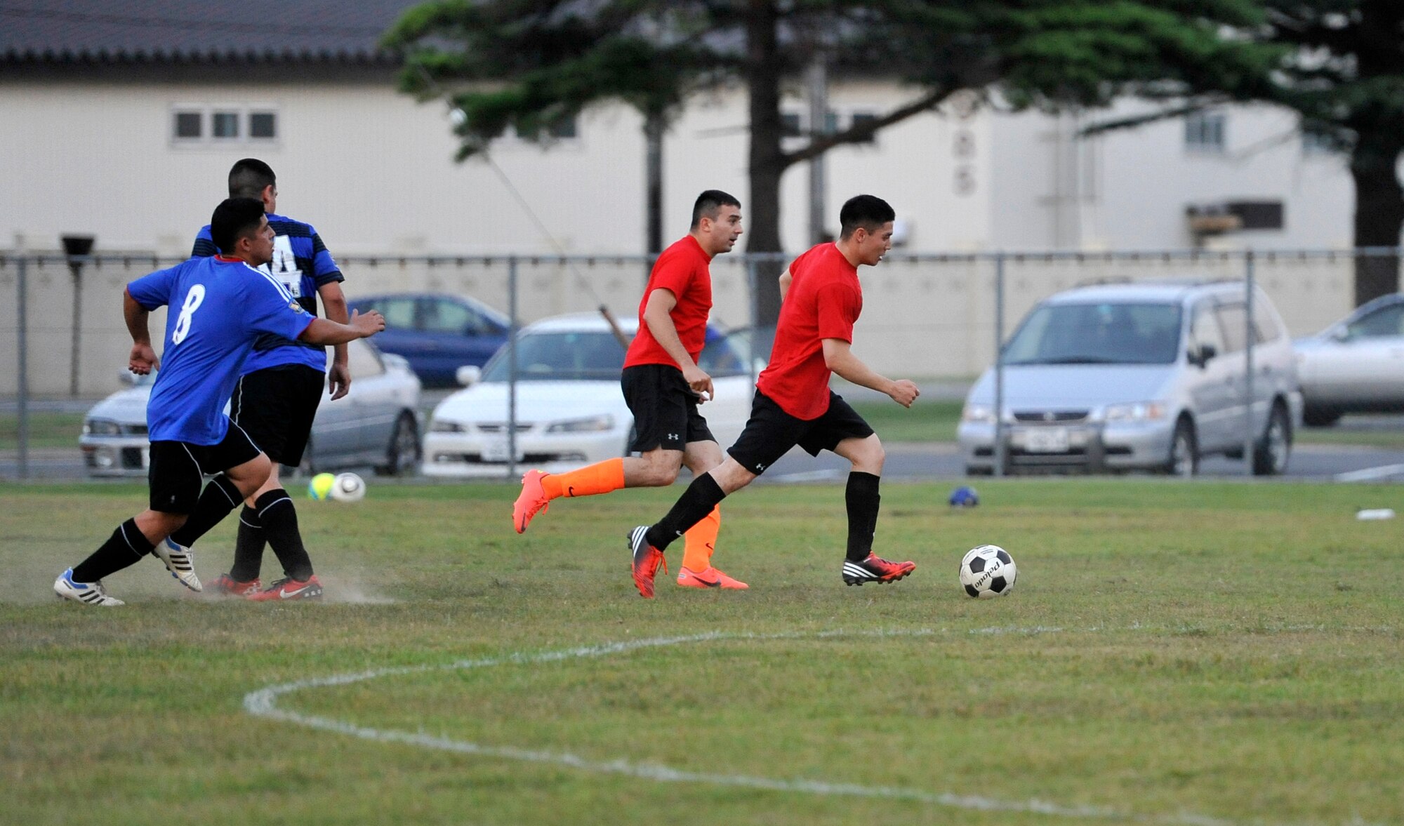 Members of the 35th Communications Squadron team steal the ball from the U.S. Navy Aircraft Intermediate Maintenance Department during an intramural soccer game at Misawa Air Base, Japan, Aug. 21, 2012. The intramural soccer season is in its second week of games at the Youth Center soccer field and will continue through Sept. 24. (U.S. Air Force photo by Airman 1st Class Zachary Kee/Released)