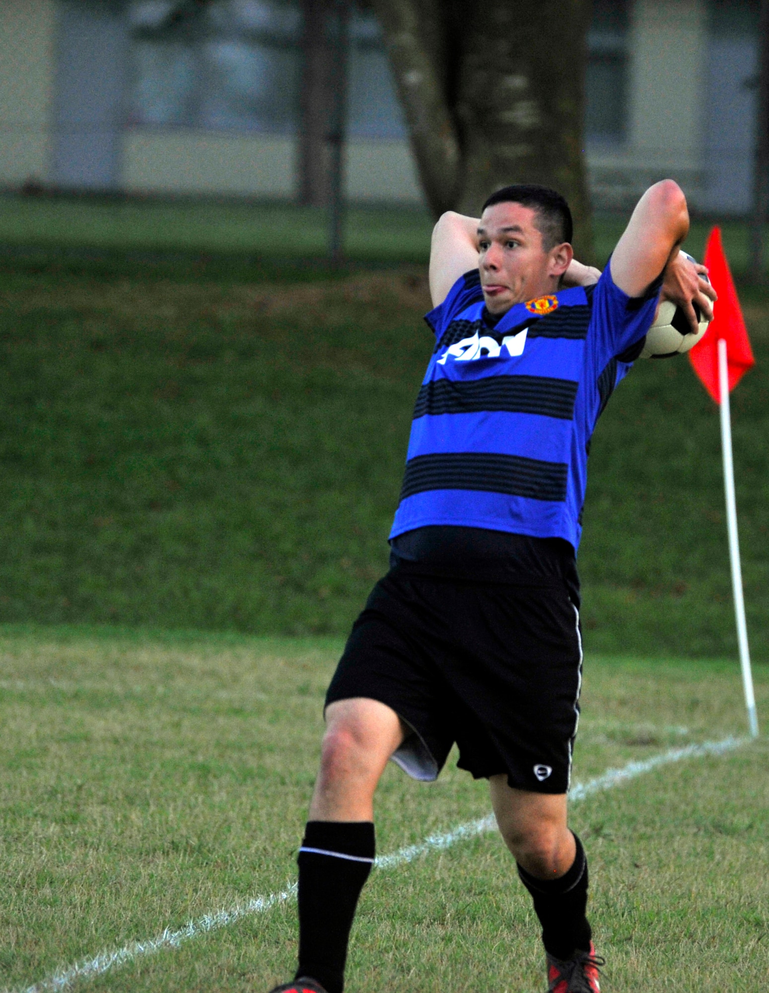 U.S. Navy Petty Officer 3rd Class Armando Flores, Aircraft Intermediate Maintenance Department, throws a ball in during an intramural soccer game at Misawa Air Base, Japan, Aug. 21, 2012. In early or mid Oct., playoffs will begin with the top five teams going for the intramural soccer championship. (U.S. Air Force photo by Airman 1st Class Zachary Kee/Released)