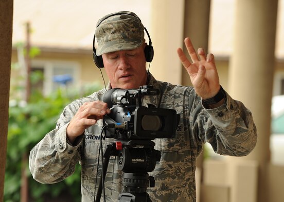 Master Sgt. John Cronin, with the Joint Hometown News Service at Fort George G. Meade, Md., counts down during a hometown news shoot on Kunsan Air Base, Republic of Korea, Aug. 23. This is part of his Pacific Air Forces tour conducting hometown news video greetings for service members. (U.S. Air Force photo/Staff Sgt. Jonathan Fowler)