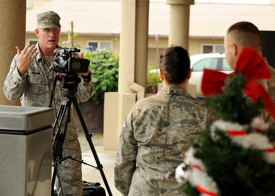 Master Sgt. John Cronin, with the Joint Hometown News Service at Fort George G. Meade, Md., speaks with Master Sgt. Hattie Douglas and Staff Sgt. Christopher Bierman, both 8th Force Support Squadron, during a hometown news shoot on Kunsan Air Base, Republic of Korea, Aug. 23. Hometown news videos are a chance for military members to send holiday greetings to friends and family while they are stationed around the world. (U.S. Air Force photo/Staff Sgt. Jonathan Fowler)