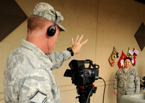 Master Sgt. John Cronin, with the Joint Hometown News Service out of Fort George G. Meade, Md. conducts a hometown news video shoot for Tech. Sgt. Torri Kuhse, 8th Force Support Squadron, on Kunsan Air Base, Republic of Korea, Aug. 23. Hometown news videos are a chance for service members to send holiday greetings to friends and family while they are stationed around the world. (U.S. Air Force photo /Staff Sgt. Jonathan Fowler)