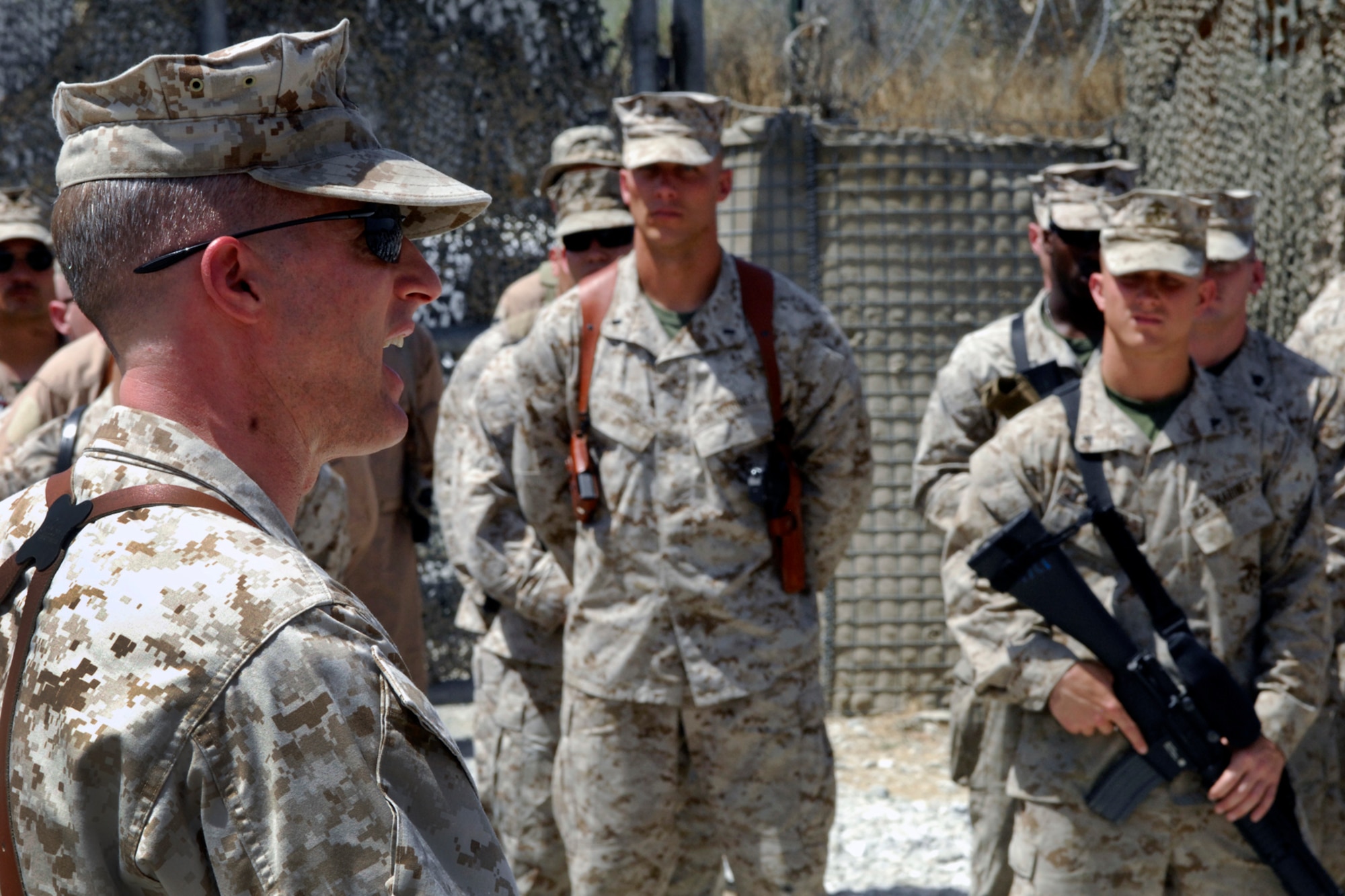 Lt. Col. Adam Musoff, U.S. Marine Tactical Electronic Warfare Squadron-2 commander (left), addresses his Marines during the Camp McCool closing ceremony at Bagram Airfield, Afghanistan, Aug. 8, 2012. The camp was named after U.S. Navy Commander William C. McCool, a space shuttle astronaut who perished when the shuttle “Columbia” broke up during reentry into Earth’s atmosphere 16 minutes before its scheduled landing. Camp McCool was opened shortly after CMDR McCool’s death. The camp had been home to the Marine Corps Prowler community since 2009. (U.S. Air Force photo/SSgt Jeff Nevison)