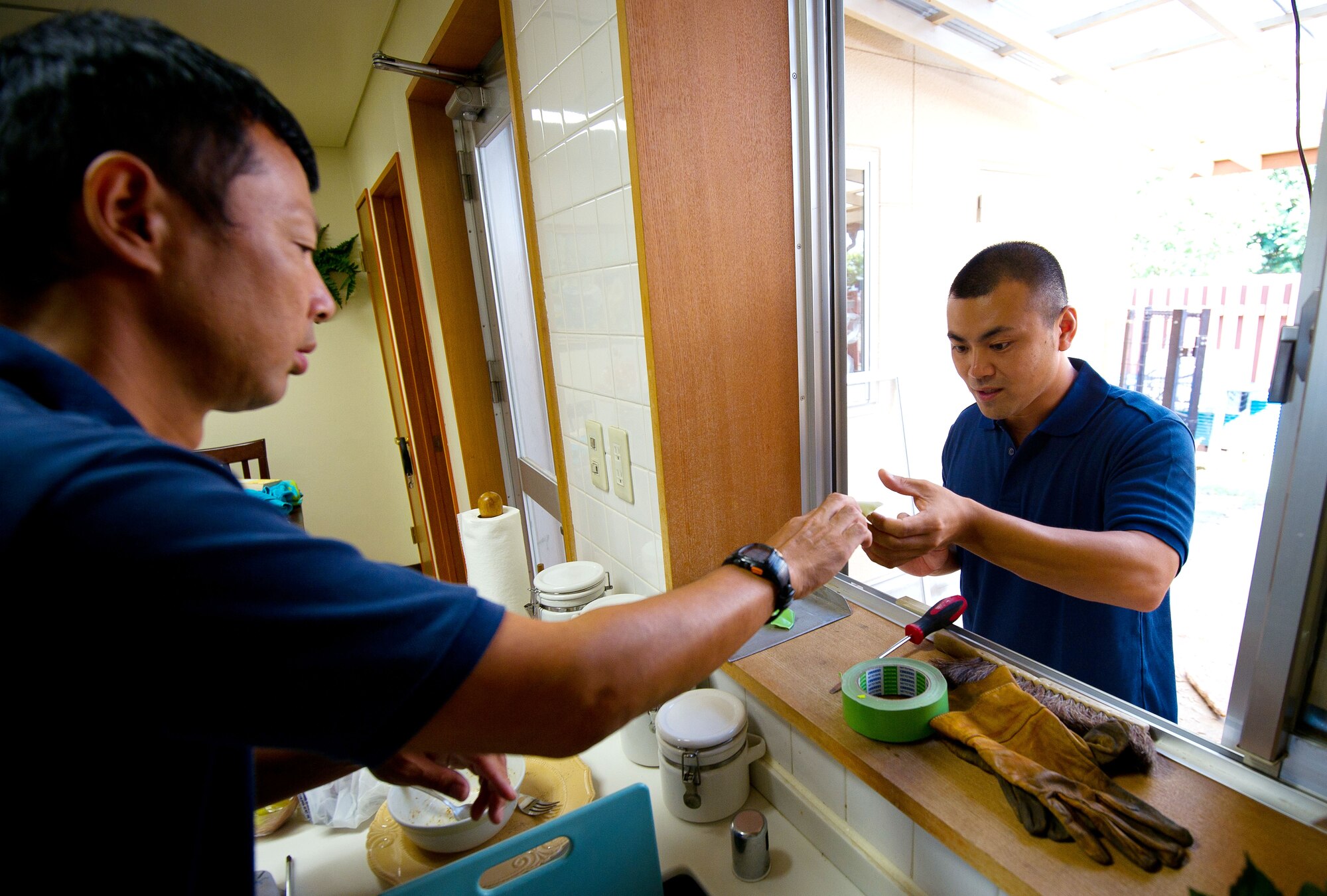 YOKOTA AIR BASE, Japan – Tsutomu Ito, left, and Junichi Sato, 374th Civil Engineer Squadron Housing Maintenance Flight repairmen, prepare a window frame for a new window to be installed at Yokota Air Base, Japan, on Aug. 23, 2012. For an average window installation, the crew usually needs half a day for preparation and installation. (U.S. Air Force photo by Staff Sgt. Chad C. Strohmeyer)