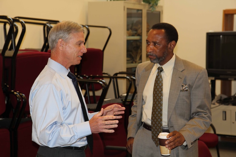 Two people discussing the specifics of the Haile Gold Mine project.