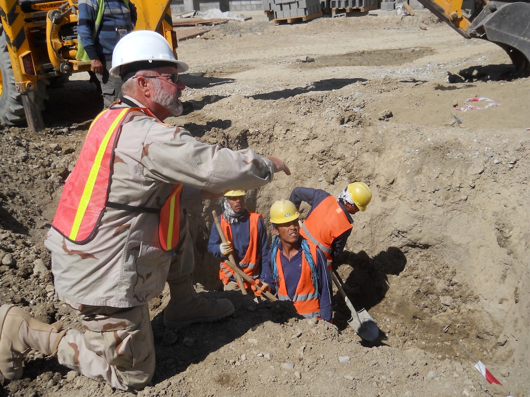 John Lindsay discussing safety procedures with workers in Afghanistan.