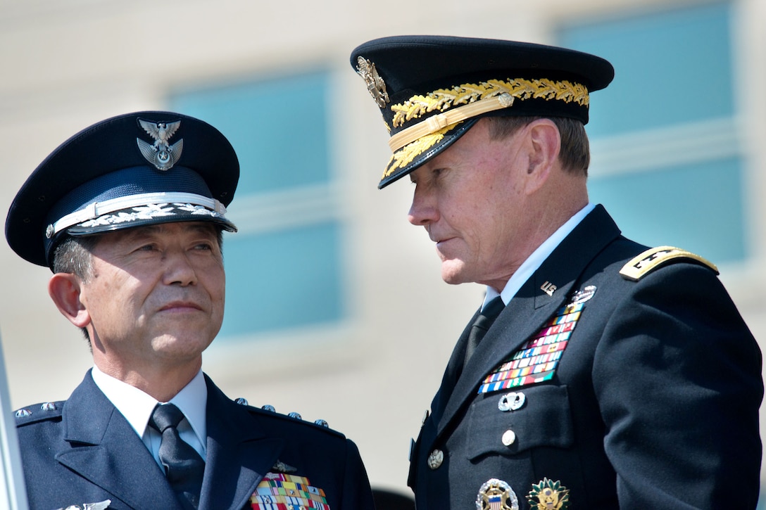 U.S. Army Gen. Martin E. Dempsey, chairman of the Joint Chiefs of Staff, welcomes Gen. Shigeru Iwasaki, chief of joint staff for Japan Self Defense Forces, during an honor cordon at the Pentagon, Aug. 23, 2012. 