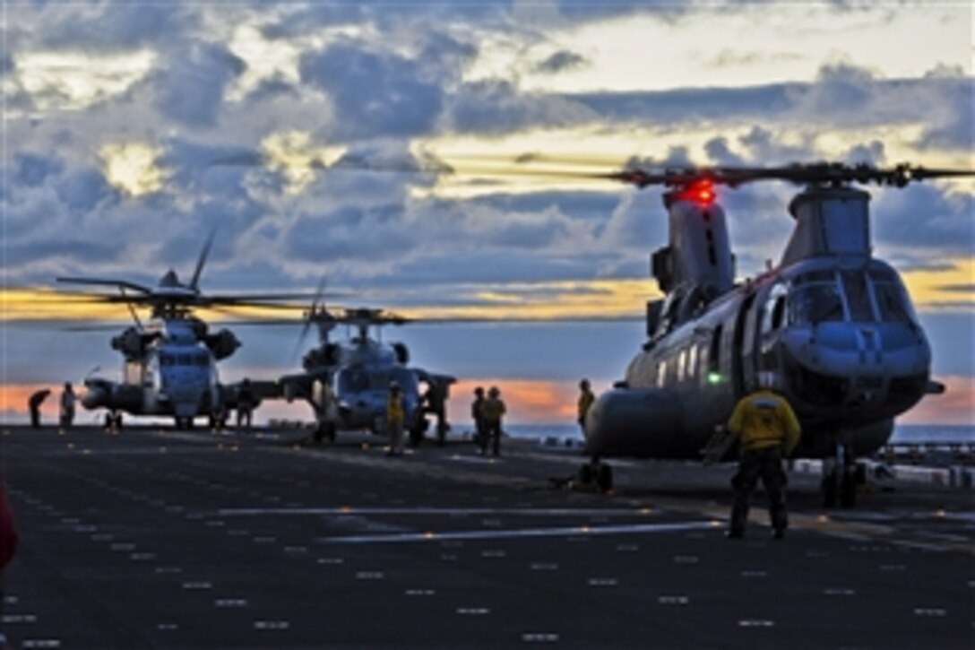 A U.S. Navy seaman prepares for flight operations aboard the amphibious assault ship USS Bonhomme Richard in the East China Sea, Aug. 24, 2012, The Bonhomme Richard is the lead ship in the only forward-deployed amphibious ready group. The seaman is an aviation boatswain's mate.