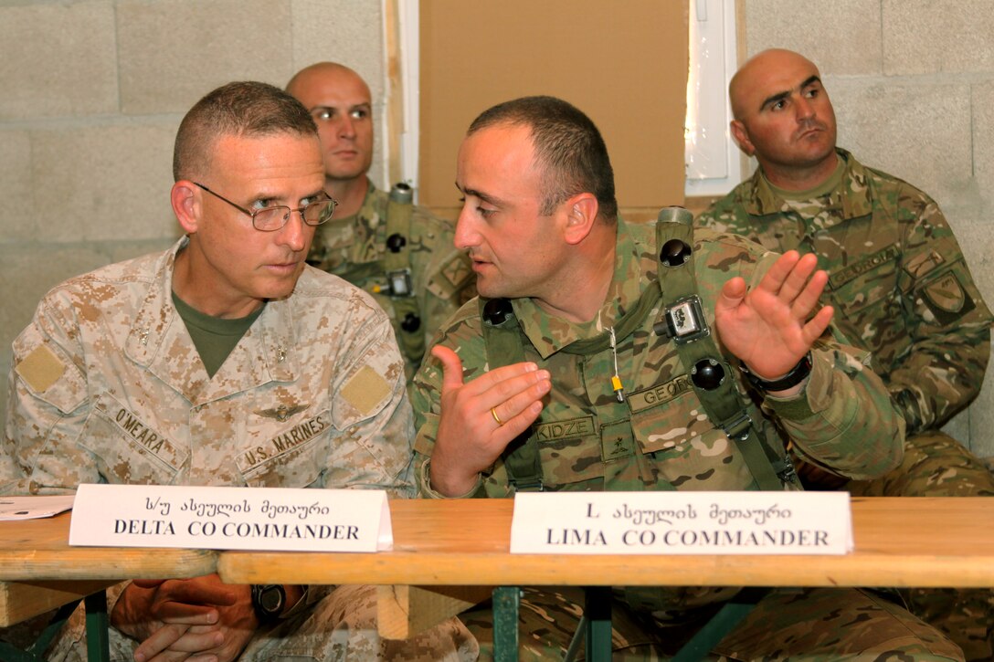Colonel James S. O'Meara, deputy commander, Marine Corps Forces, Europe/Africa sits in a brief given by Georgian soldiers assigned to the 12th and 32rd Georgian battalions during the Marine Rehearsal Exercise Distinguished Visitor day. During the course of the day the men and members of their staff, sat through briefs and toured the training area. The MRE is a culmination exercise for two Georgian Army battalions: the 12th and 32rd battalions will complete the MRE and will deploy to Afghanistan in support of the International Securtiy Assistance Force.




