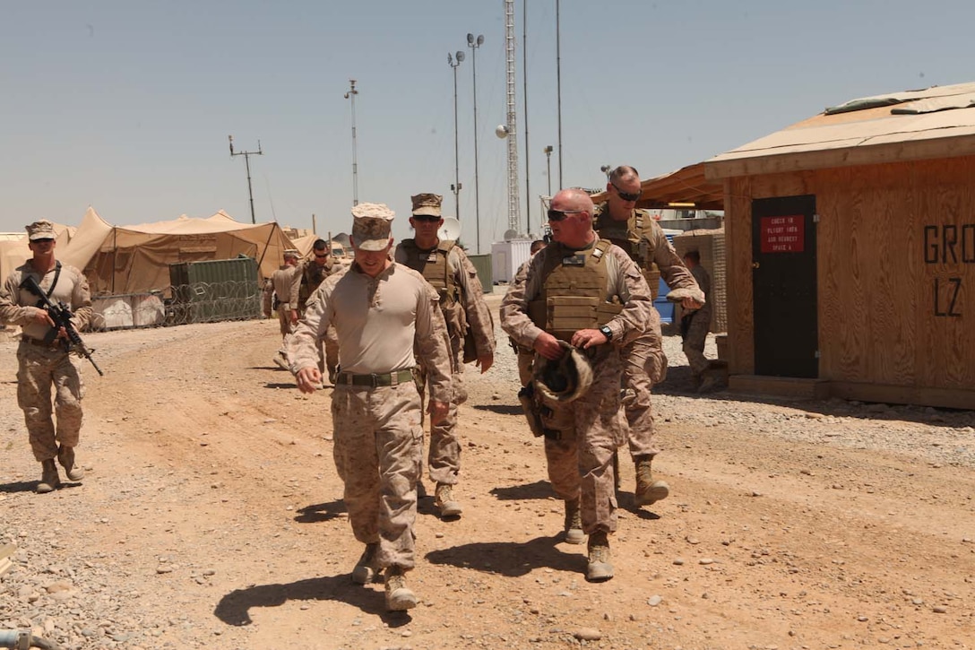 U.S. Marine Corps Lt. Col. Edward J. Healey, left, battalion commander of 3rd Battalion, 8th Marine Regiment (3/8), Regimental Combat Team 6 and Maj. Gen. Walter L. Miller, right, commanding general of Marine Air Ground Task Force 13 walk to the command operations center on Forward Operating Base (FOB) Geronimo, Helmand province, Afghanistan Aug. 18, 2012. Maj. Gen. Miller along with Task Force Leatherneck command staff visited FOB Geronimo to discuss future operations in the 3/8 area of operation. (U.S. Marine Corps photo by Lance Cpl. Cesar N. Contreras/Released)