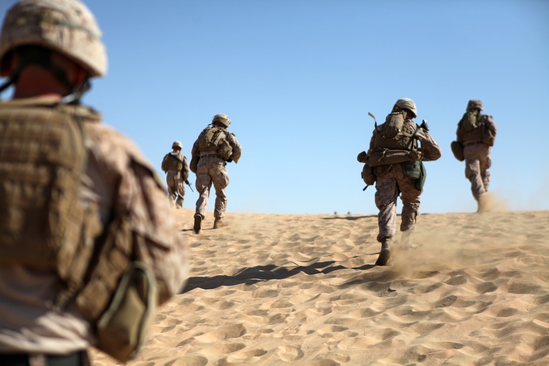 UDAIRI RANGE, Kuwait (Aug. 15, 2012) U.S. Marines assigned to 2nd Platoon, Charlie Company, Battalion Landing Team 1st Battalion, 2nd Marine Regiment, 24th Marine Expeditionary Unit, rush up a hill to assume attack positions during live-fire platoon attack training at Udairi Range in Kuwait, Aug. 15, 2012. The 24th MEU is deployed with the Iwo Jima Amphibious Ready Group as a U.S. Central Command theater reserve force providing support for maritime security operations and theater security cooperation efforts in the U.S. 5th Fleet area of responsibility. (U.S. Marine Corps photo by Sgt. Richard Blumenstein/Released)