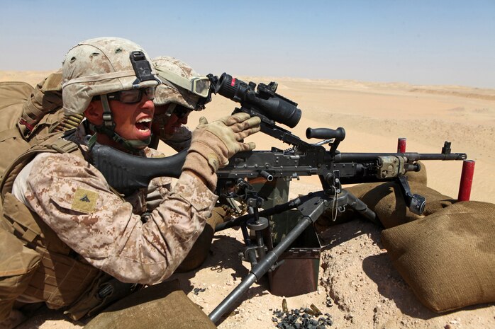 UDAIRI RANGE, Kuwait (Aug. 15, 2012) A U.S. Marine machine gunner assigned to 2nd Platoon, Charlie Company, Battalion Landing Team 1st Battalion, 2nd Marine Regiment, 24th Marine Expeditionary Unit, shouts "gun down" during live-fire platoon attack training at Udairi Range in Kuwait, Aug. 15, 2012. The 24th MEU is deployed with the Iwo Jima Amphibious Ready Group as a U.S. Central Command theater reserve force providing support for maritime security operations and theater security cooperation efforts in the U.S. 5th Fleet area of responsibility. (U.S. Marine Corps photo by Sgt. Richard Blumenstein/Released)