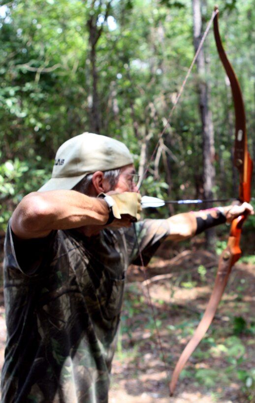 An archer prepares to strike a target during the Frogman 3-D Bowhunter Challenge Aug 18 in Jacksonville, N.C., Shooters had 22 foam 3-D animal replicas to shoot, including a velociraptor.  