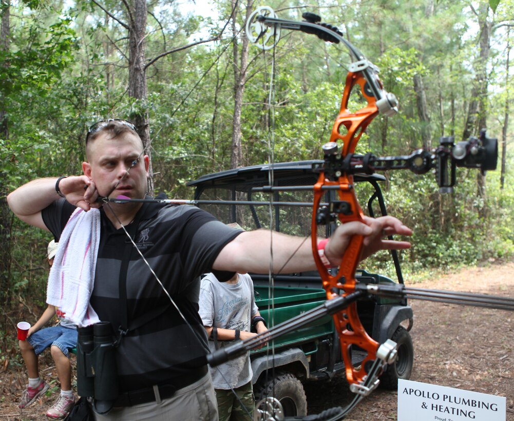 Maj. Richard Burkett, a V-22 pilot with Marine Medium Tiltrotor Squadron 261, Marine Aircraft Group 26, aims at a target during the Frogman 3-D Bowhunters Challenge Aug. 18 in Jacksonville, N.C. Burkett was injured in a helicopter crash and he wanted to support wounded warrior organizations while partaking in an activity he loves.  