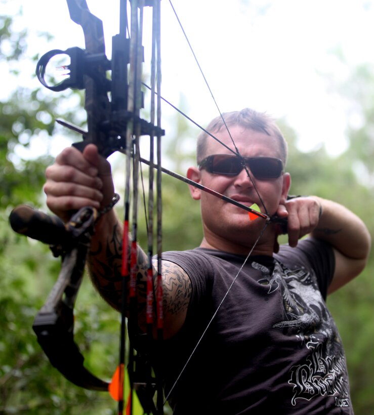 Sgt. Cameron Greenwood, a Marine with Marine Special Operations Command, takes aim at a 3-D foam bear during the Frogman 3-D Bowhunters Challenge Aug. 18. Greenwood was there to take part in an activity he enjoys, archery, while supporting wounded warriors and honoring the memory of fallen Navy SEAL, Chief Petty Officer Chris Campbell. 