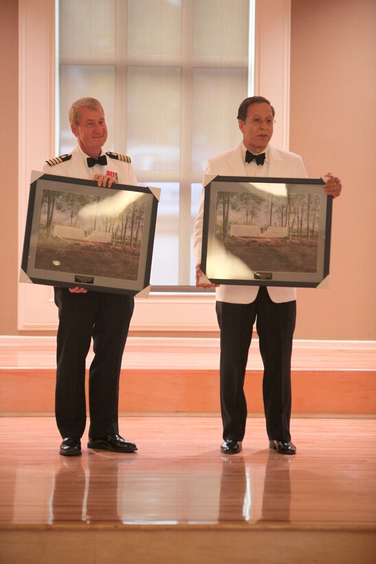 Navy Captains James J. Ware (left) and Gilbert Bigelow, two retired dental officers, hold pictures of the Beirut Memorial, which they received during the Navy’s Dental Corps’ 100th anniversary ball aboard Camp Lejeune, N.C., Aug. 18, 2012.  Ware and Bigelow provided medical assistance to troops during the Beirut attack and were the guests of honor for the ball. 