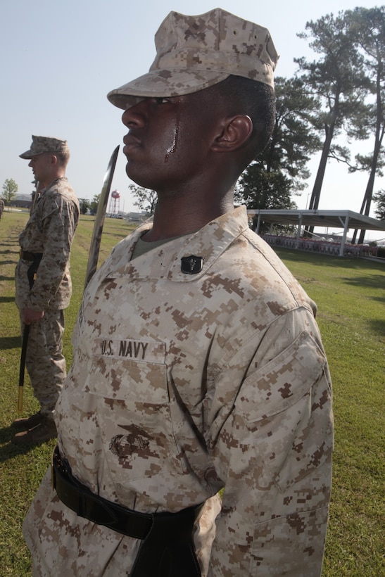 Petty Officer 3rd Class Carnell Tarver, a hospital corpsman with Naval Health Clinic Cherry Point and a student at Cherry Point Corporals Leadership Course Class 274-12, holds his "draw sword" during an introduction to sword manual, Aug. 17. The three-week course is the first Professional Military Education class enlisted Marines attend and focuses on leadership, history and tradition of Marine Corps corporals.