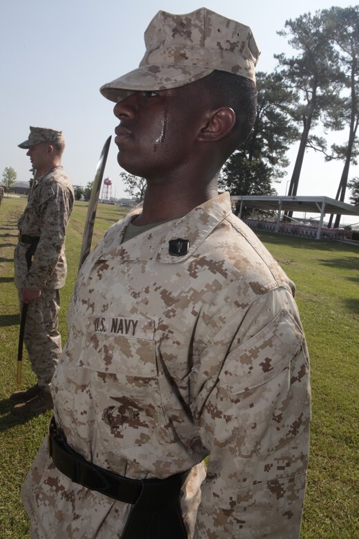 Petty Officer 3rd Class Carnell Tarver, a hospital corpsman with Naval Health Clinic Cherry Point and a student at Cherry Point Corporals Leadership Course Class 274-12, holds his "draw sword" during an introduction to sword manual, Aug. 17. The three-week course is the first Professional Military Education class enlisted Marines attend and focuses on leadership, history and tradition of Marine Corps corporals.
