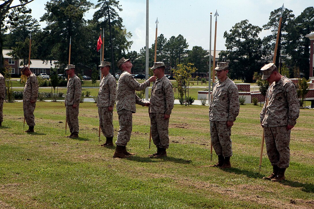 Sgt. Stephen W. Ford, an instructor for Cherry Point Corporals Leadership Course, inspects a students guidon, during an introduction to guidon manual, Aug. 17. The three-week course is the first Professional Military Education class enlisted Marines attend and focuses on leadership, history and tradition of Marine Corps corporals.