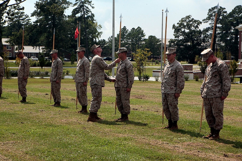 Sgt. Stephen W. Ford, an instructor for Cherry Point Corporals Leadership Course, inspects a students guidon, during an introduction to guidon manual, Aug. 17. The three-week course is the first Professional Military Education class enlisted Marines attend and focuses on leadership, history and tradition of Marine Corps corporals.