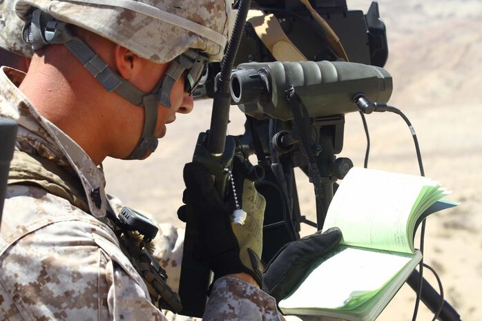 Sgt. Shaye Carter, platoon sergeant, Personal Security Detail, Regimental Combat Team-7, radios target information during a Fire Support Coordination Exercise as part of Enhanced Mojave Viper 7-12, July 24. Carter, the joint fires observer for PSD, provided grid coordinates and simulated targets to the Marines providing close air support.