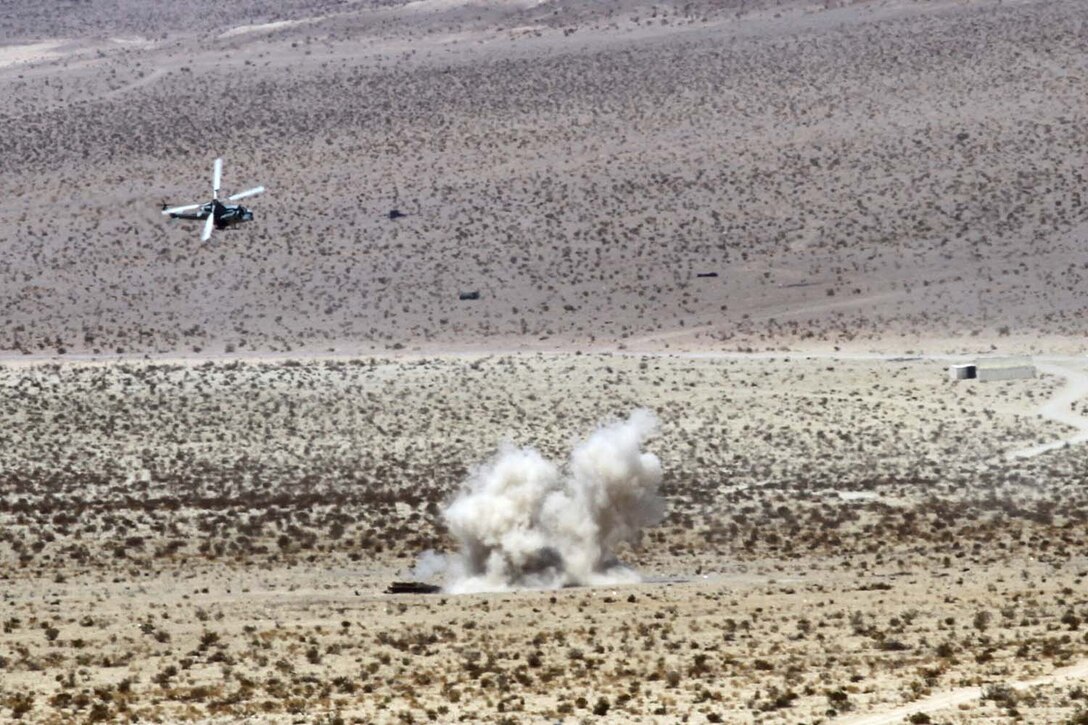An UH-1Y 'Venom' flies over a simulated target during a Fire Support Coordination Exercise as part of Enhanced Mojave Viper 7-12, July 24. The helicopters assaulted the simulated targets with machine-gun fire and simulated missiles.