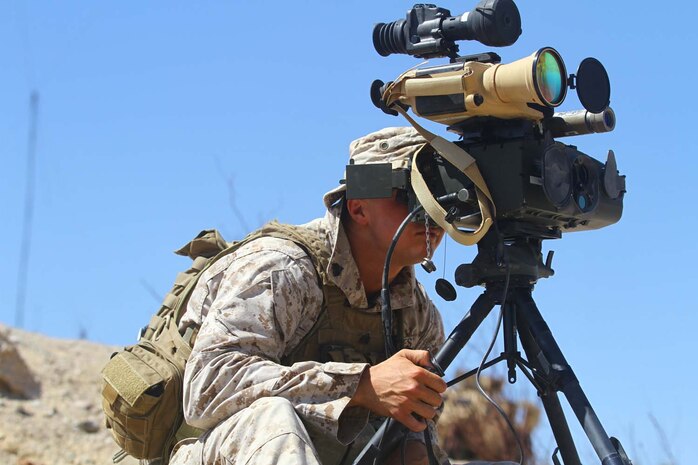 Sgt. Shaye Carter, platoon sergeant, Personal Security Detail, Regimental Combat Team-7, looks through the Portable Lightweight Designator/Rangefinder during a Fire Support Coordination Exercise as part of Enhanced Mojave Viper 7-12, July 24. Carter, the joint fires observer for PSD, coordinated with close air support to ensure simulated targets were properly destroyed.