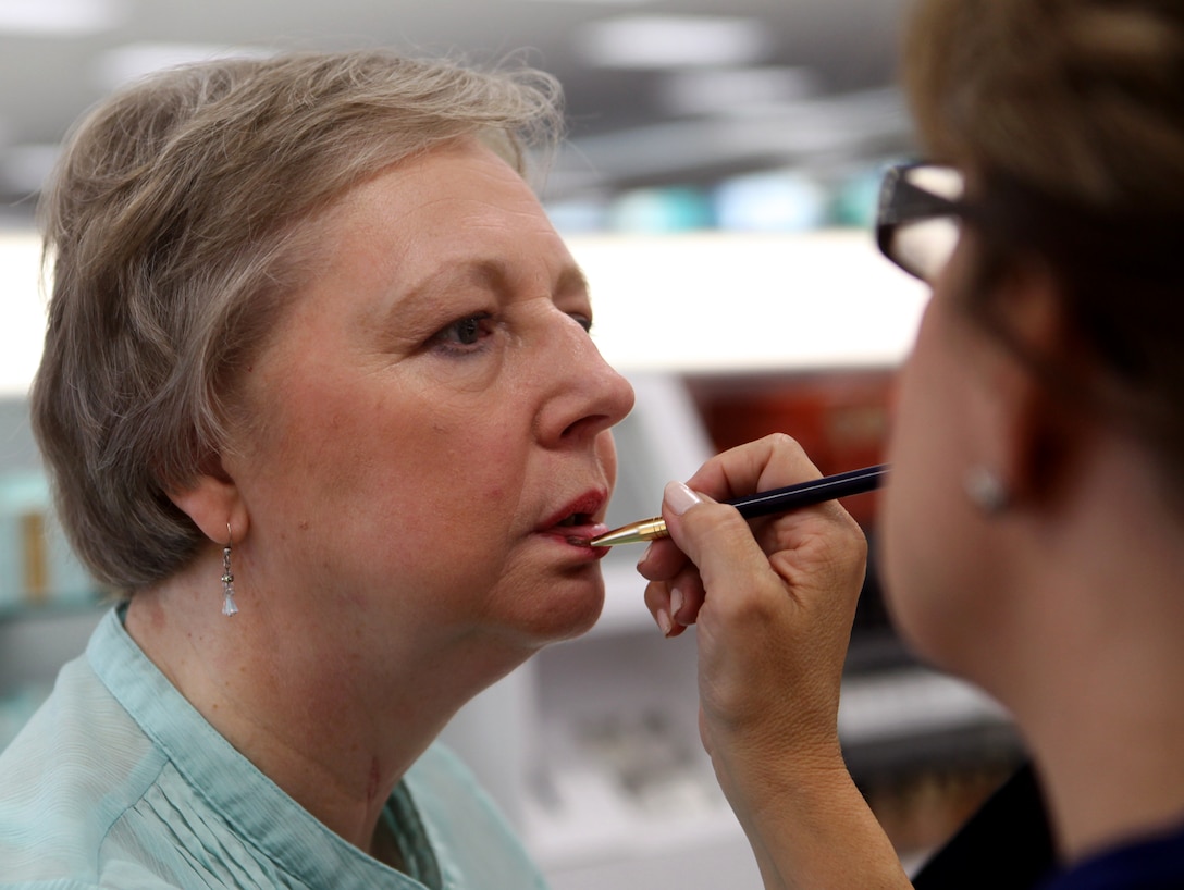 Susan King has makeup applied to her face by Debi Vincent, a makeup artist and the business manager of a cosmetics company aboard Marine Corps Base Camp Lejeune Aug. 17. King came to the Marine Corps Exchange's cosmetics department looking for a new look to wear to her son's wedding.