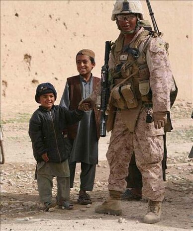 A Marine from Golf Company, 2d Battalion, 5th Marines with local Afghan children.