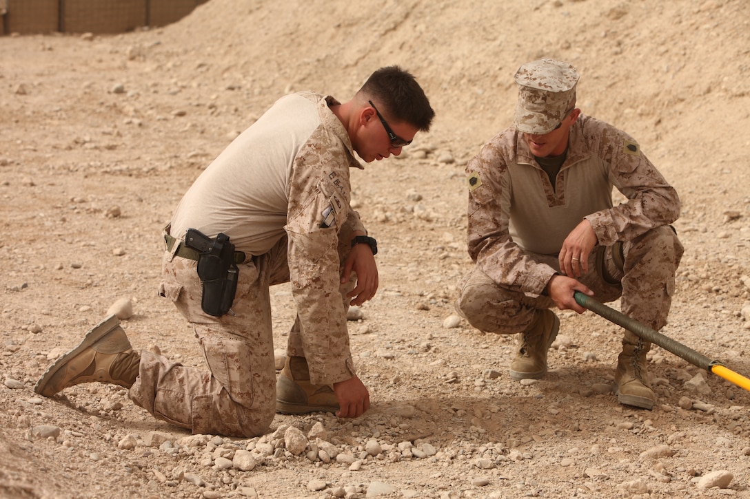 Sgt. Jesse Early, (left) explosive ordnance disposal technician, 1st EOD Co., 1st Marine Logistics Group (Forward), observes a possible improvised explosive device location with a participant in the counter IED lanes course at Camp Leatherneck, Afghanistan, Aug. 25. During the course, Marines and sailors from various forward deployed units learn new methods of IED detection.